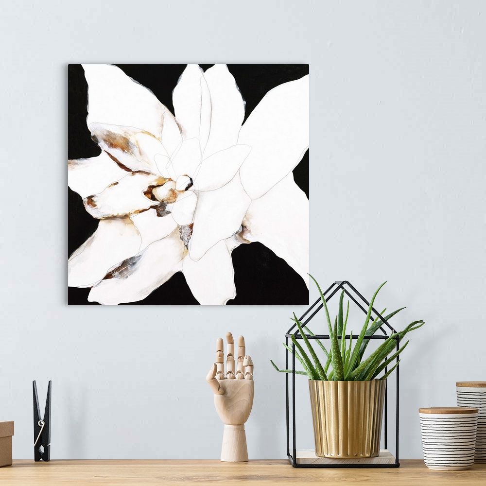 A bohemian room featuring Contemporary abstract painting using resembling a white flower against a black background.