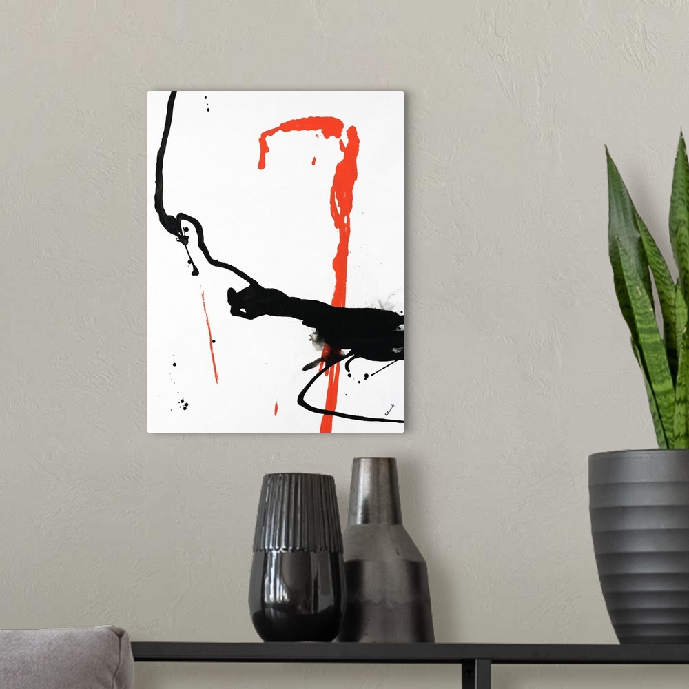 A modern room featuring This white blank surface is an abstract piece of artwork splashed with a dash of black and orange...