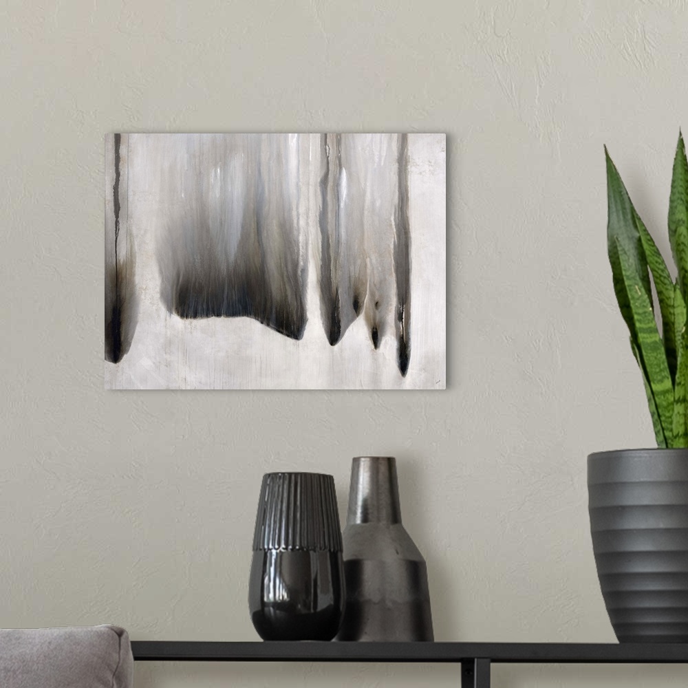 A modern room featuring Abstract art of several dark lines of ink that appear to have been mixed with water and run in an...