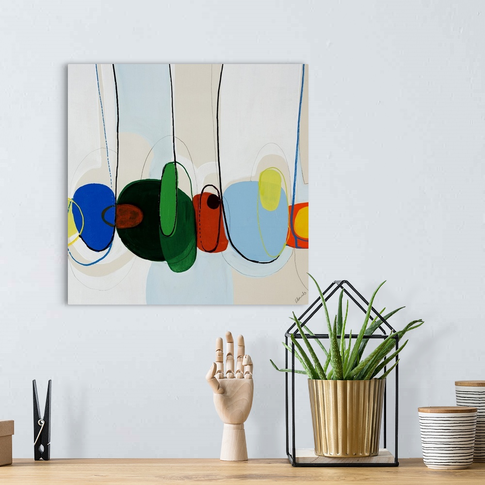 A bohemian room featuring Contemporary abstract artwork depicting giant candy beans squished together in a row.