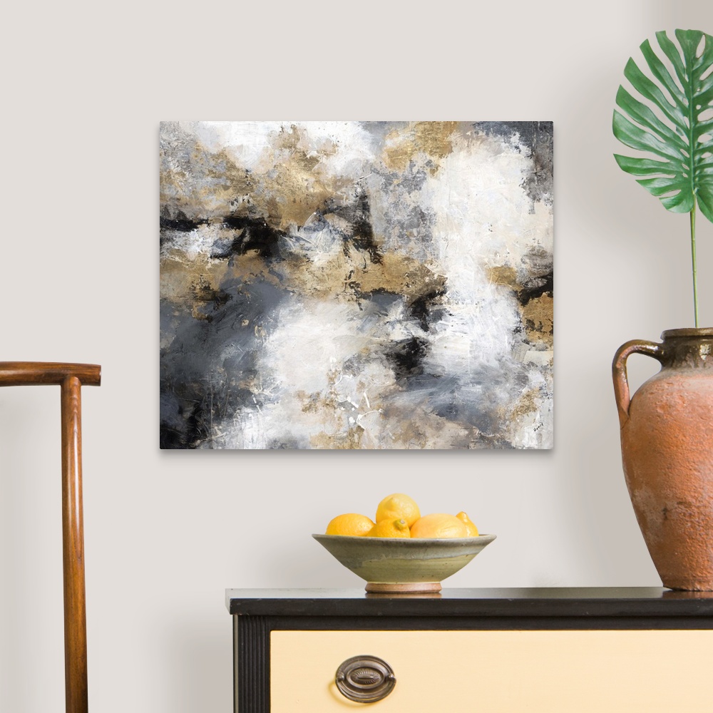 A traditional room featuring Contemporary abstract artwork in shades of gold, grey, and white, resembling a stormy sky.