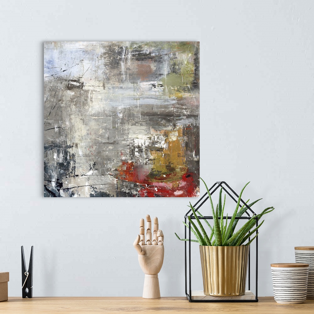 A bohemian room featuring Square abstract painting of textured natural colors such as gray, brown and red.