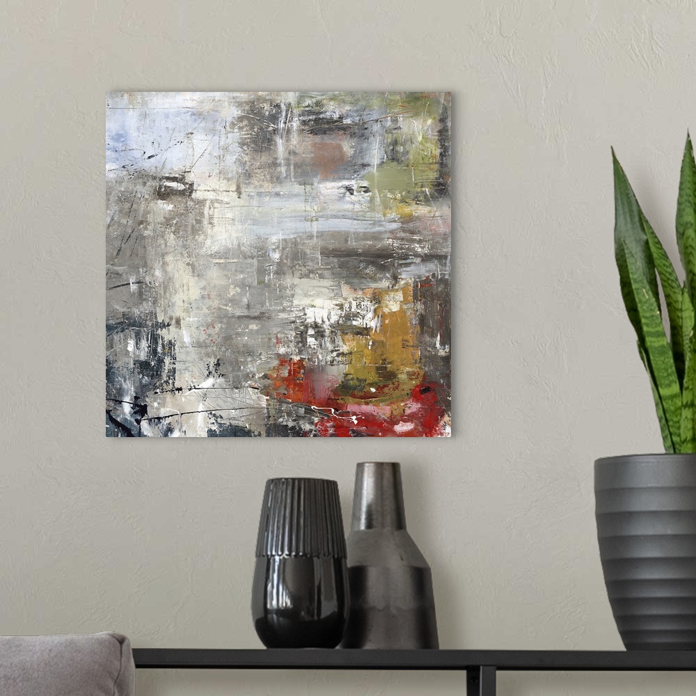 A modern room featuring Square abstract painting of textured natural colors such as gray, brown and red.