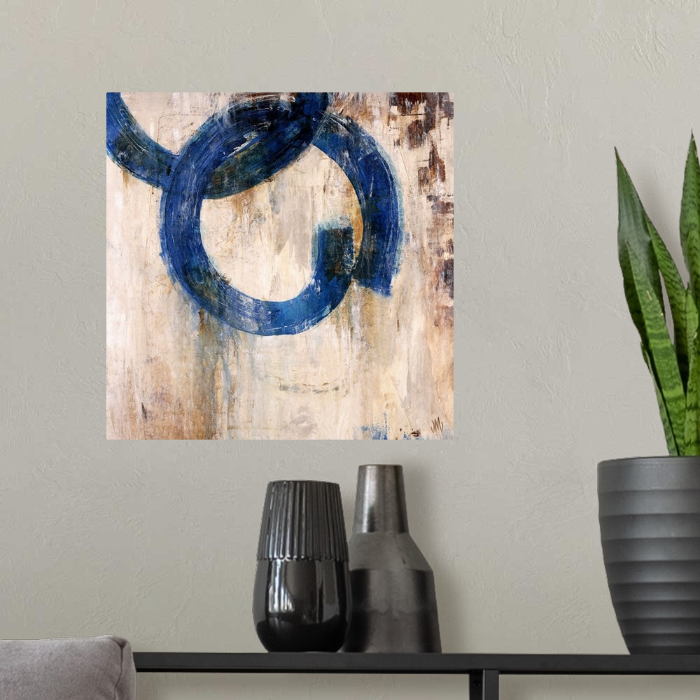 A modern room featuring Abstract artwork of a mostly neutral background that has two blue rings that are interlocked.