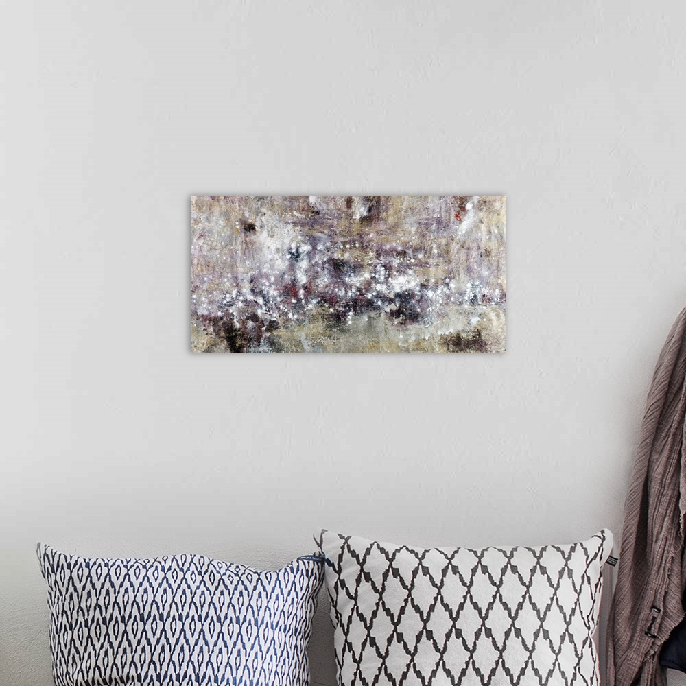 A bohemian room featuring Abstract artwork whose edges are neutral and white speckled throughout this horizontal piece.