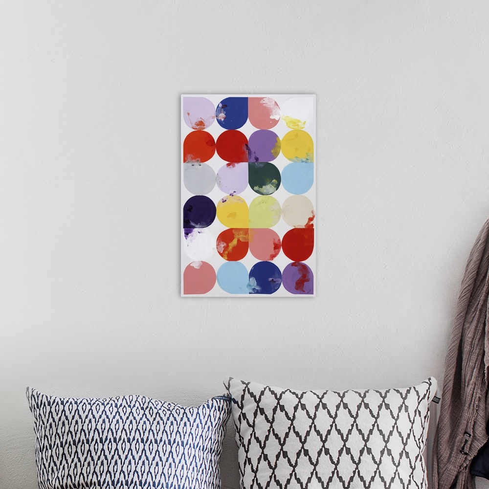 A bohemian room featuring Vertical painting of rows of tear drops shapes in different colors.