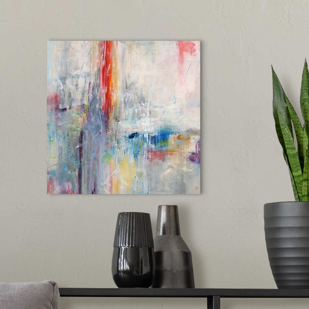 A modern room featuring Bright abstract contemporary painting in rainbow colors.
