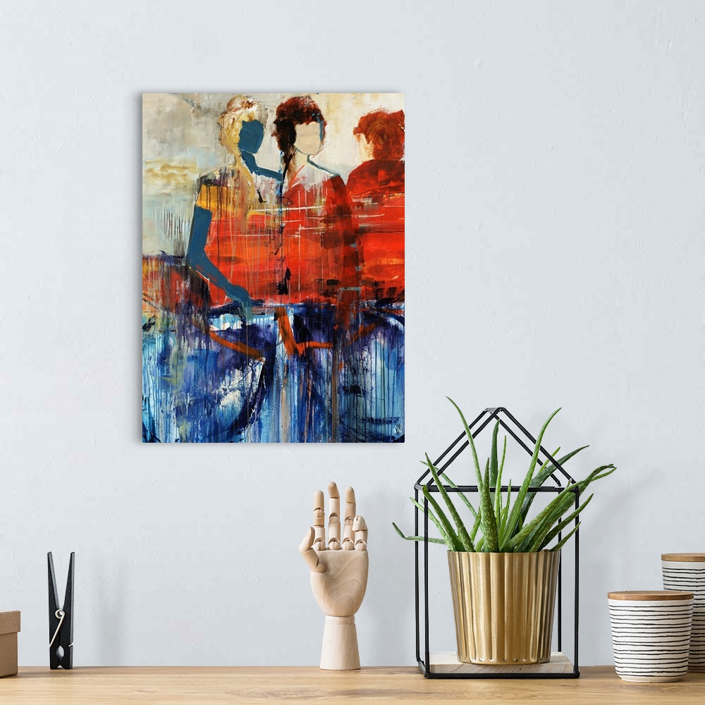 A bohemian room featuring Portrait, figurative art on a large wall hanging of three human figures standing behind a large o...