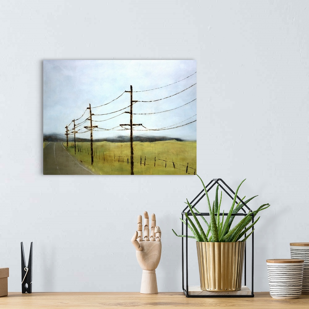 A bohemian room featuring Landscape painting of electrical poles and lines in an empty field, alongside a paved road that l...