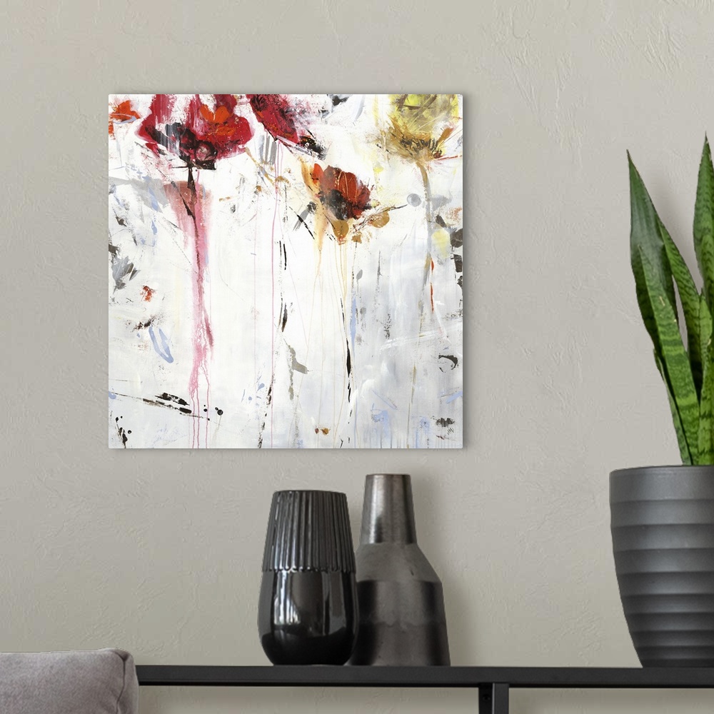 A modern room featuring Square abstract floral painting in shades of red, orange and white.