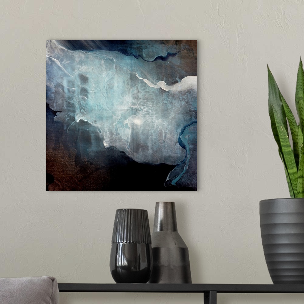 A modern room featuring Abstract art of bright colors resembling smoke wafting on a dark background.