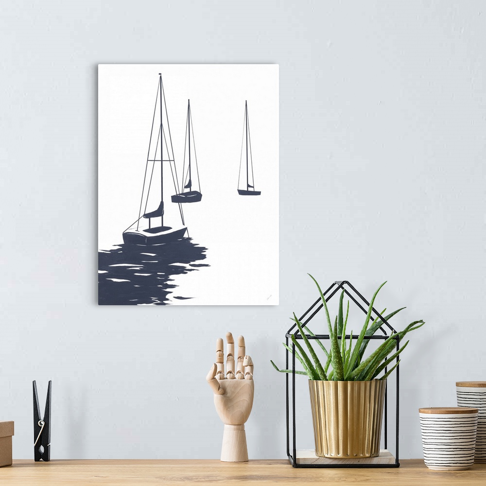 A bohemian room featuring A modest design in white and dark blue of a few sailboats floating in the water.
