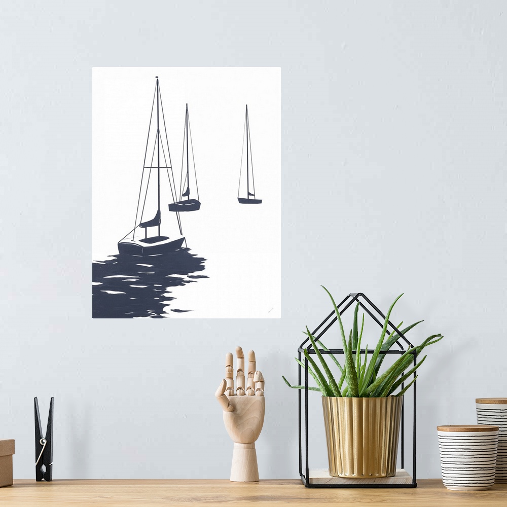A bohemian room featuring A modest design in white and dark blue of a few sailboats floating in the water.