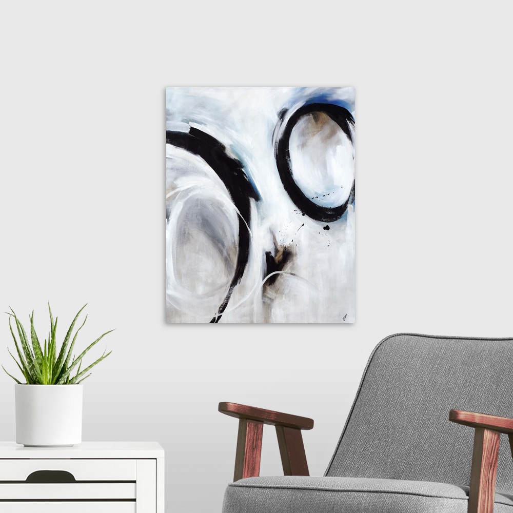 A modern room featuring Abstract artwork of strong black circular strokes over a soft blue and grey background.