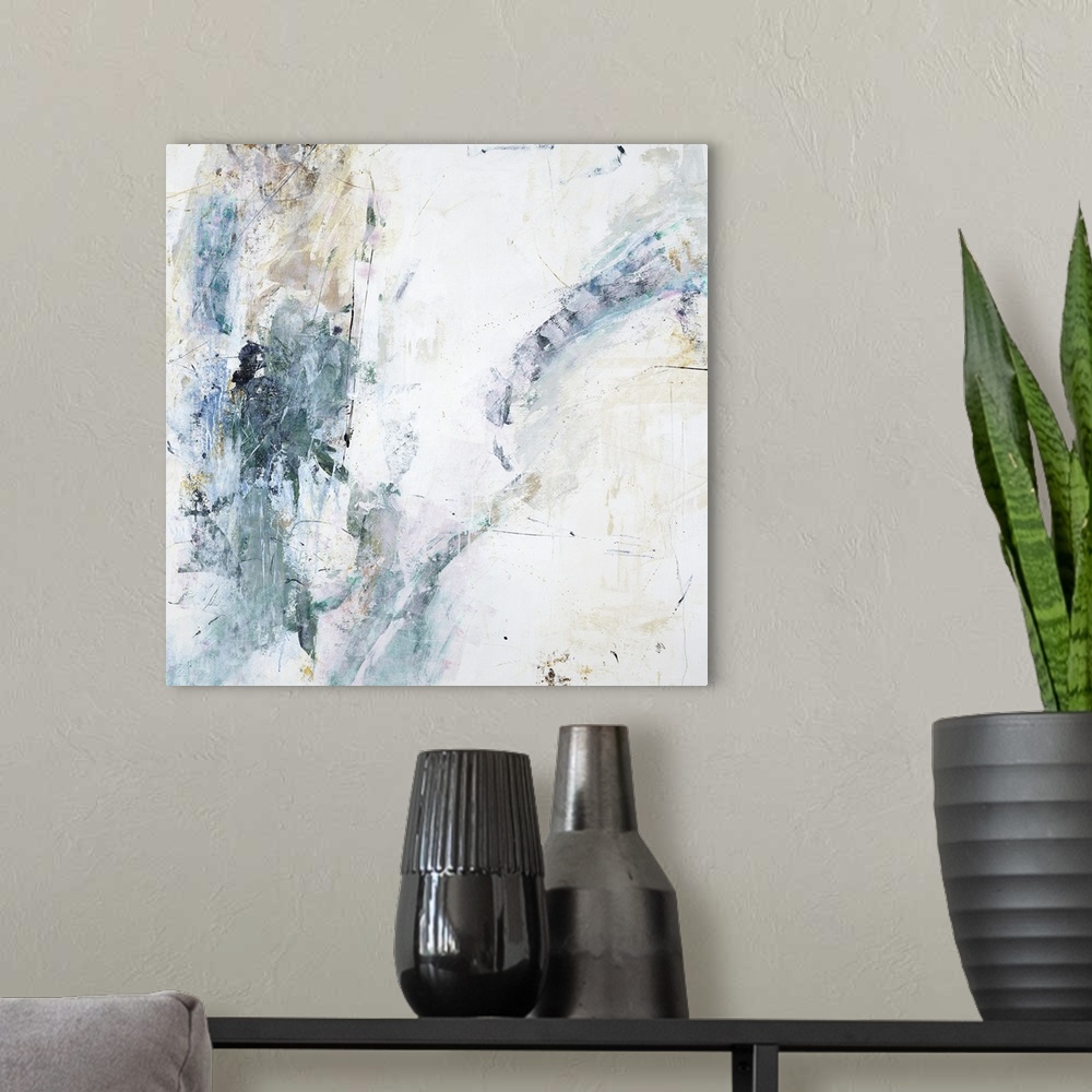 A modern room featuring Square abstract painting of faint textured colors such as gray, brown and white