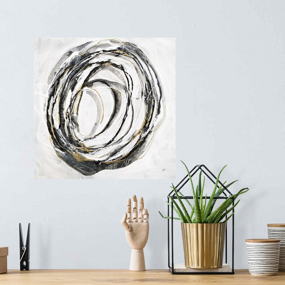 A bohemian room featuring Square abstract art with thin black, gray, and gold lines making one big circle in the center of ...