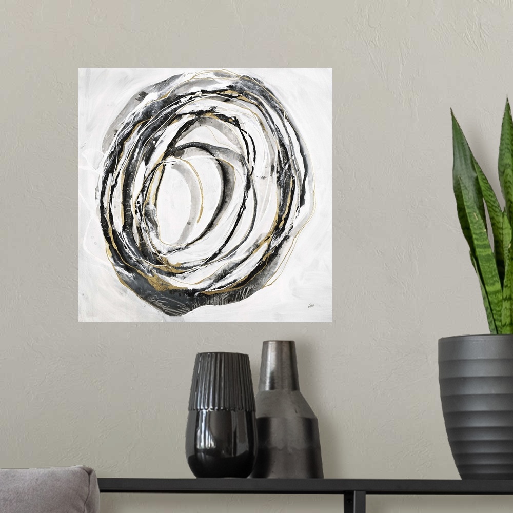 A modern room featuring Square abstract art with thin black, gray, and gold lines making one big circle in the center of ...
