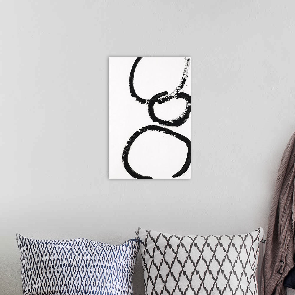 A bohemian room featuring Three black circles stacked on top of each other on a white background.