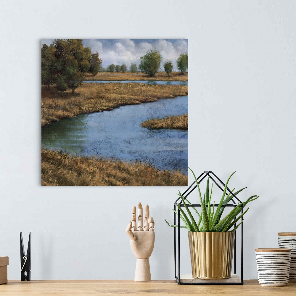 A bohemian room featuring Contemporary painting of an idyllic countryside landscape, with a winding river.