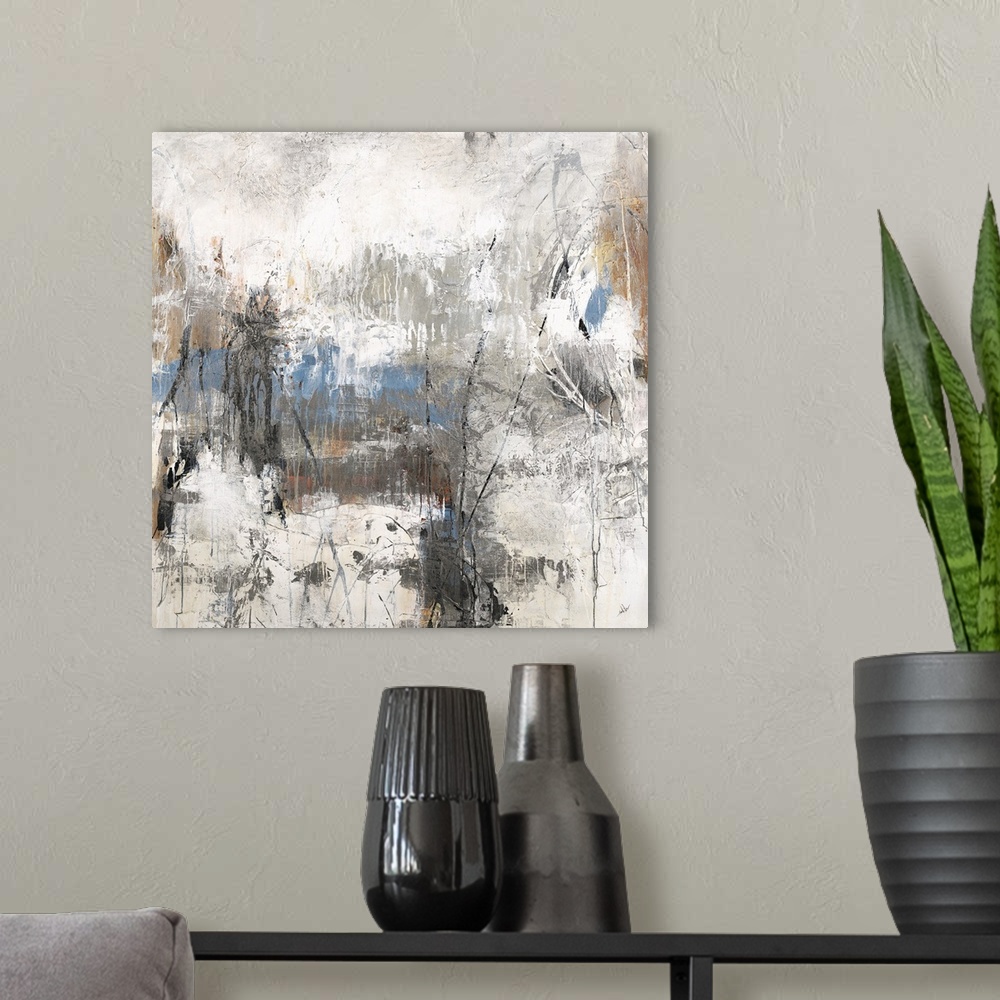 A modern room featuring Square abstract art with blue, brown, and black hues surrounded by neutral grays and whites.
