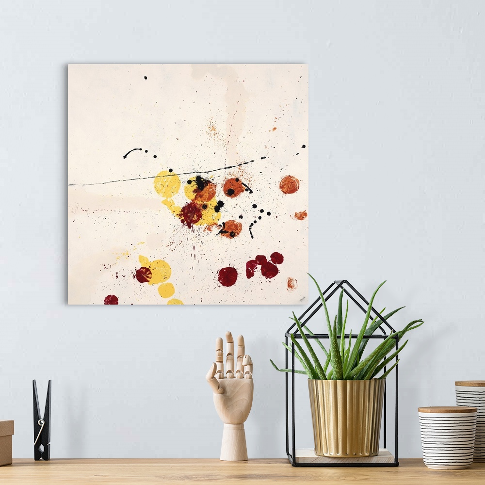 A bohemian room featuring Abstract painting using red and yellow paint splatters on a neutral toned background.