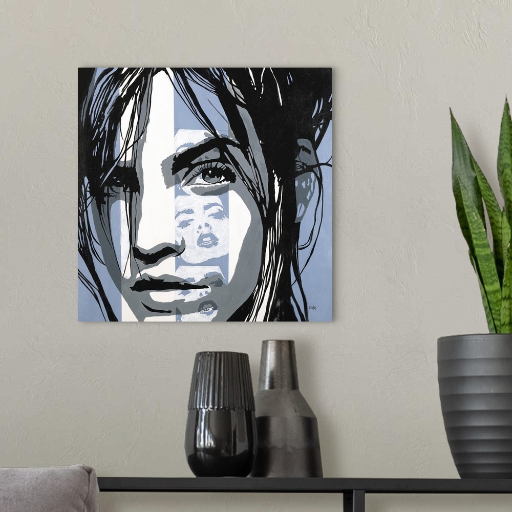 A modern room featuring Square art with a woman's face in black, white, and powder blue, and a strip of white silhouettes...