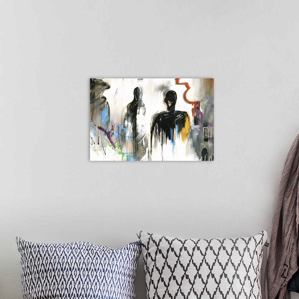 A bohemian room featuring Large abstract painting with dark figures and sporadic lines and shapes in various bright hues.