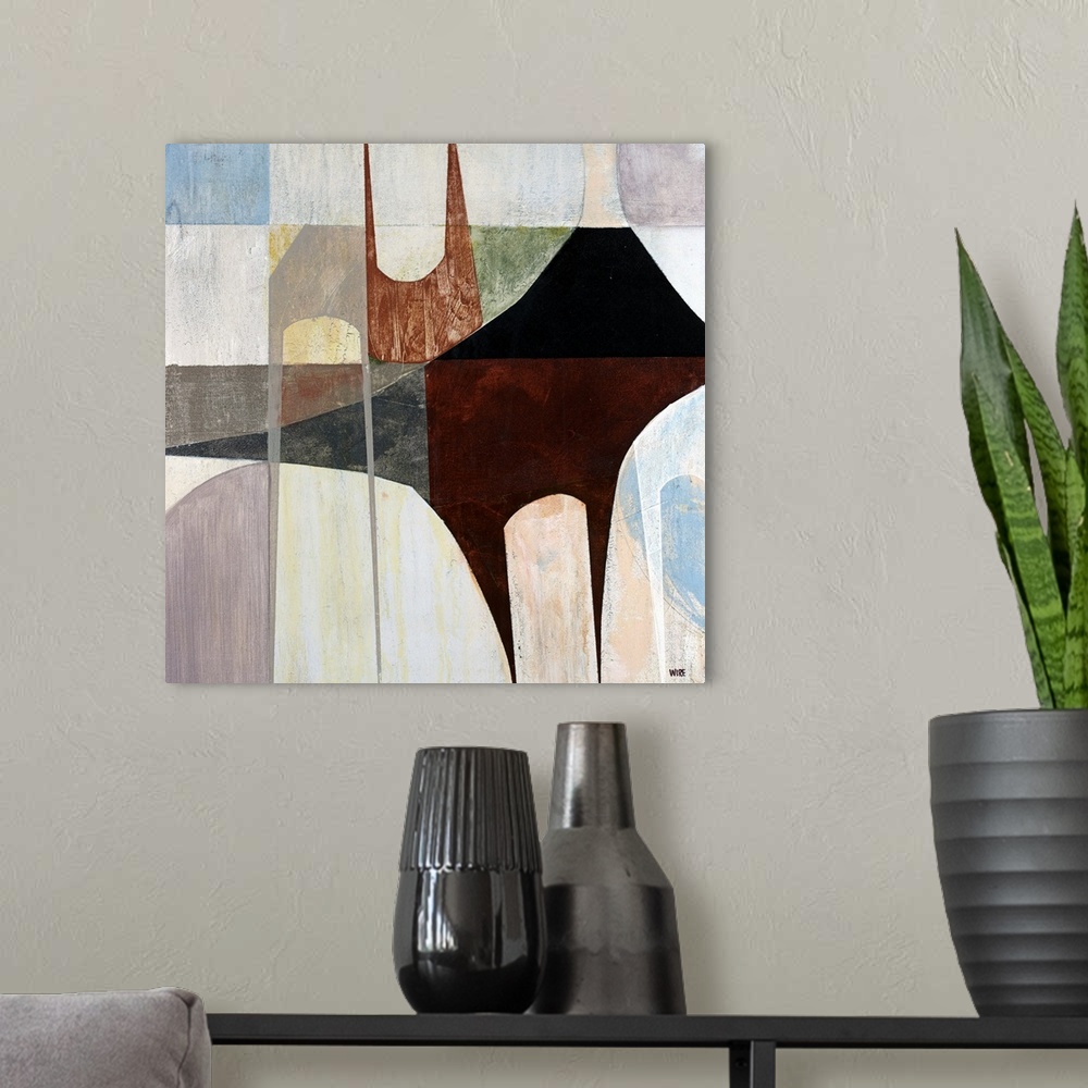 A modern room featuring Abstract artwork that uses blocks of colors with black and brown patterns laid over top.