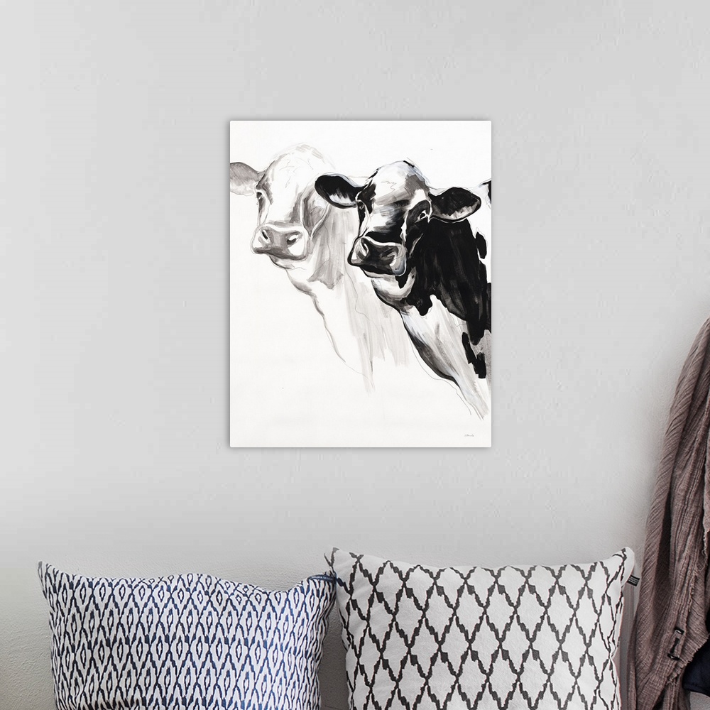 A bohemian room featuring Black and white panting of two cows on a white background.