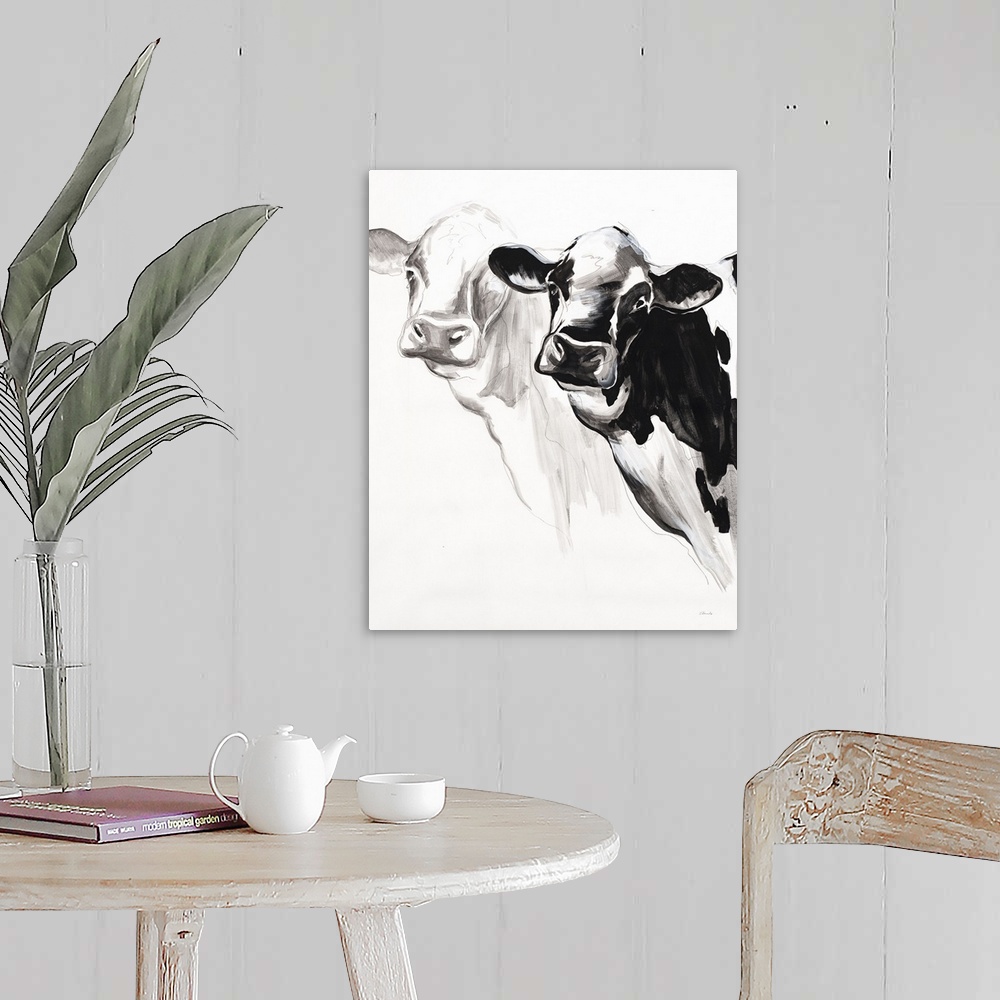 A farmhouse room featuring Black and white panting of two cows on a white background.