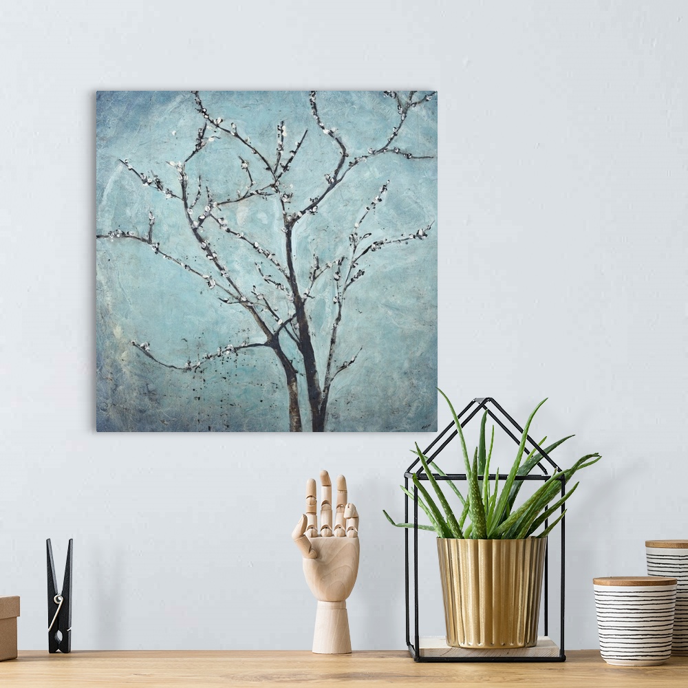A bohemian room featuring Contemporary painting of flowering branches against a hazy blue background.
