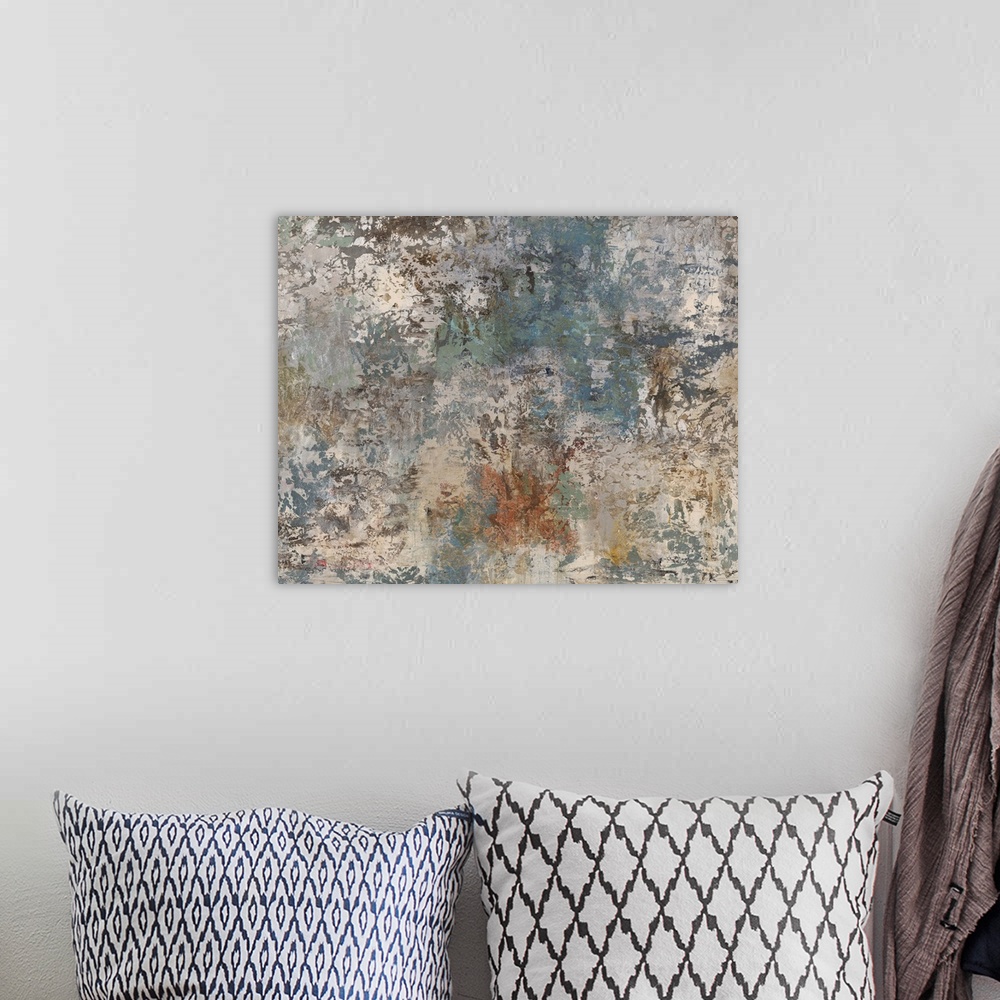A bohemian room featuring Abstract painting using earth tones to create a grungy and rustic piece of art.