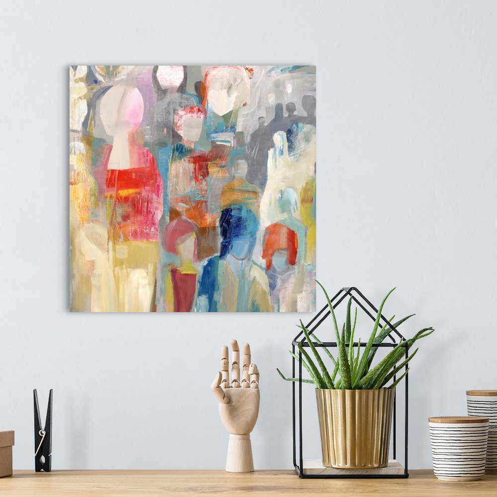 A bohemian room featuring Square abstract painting of colorful figures stacked together.