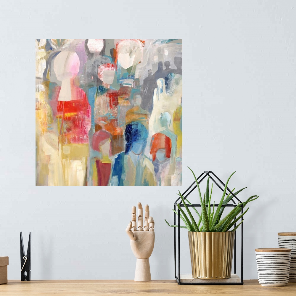A bohemian room featuring Square abstract painting of colorful figures stacked together.