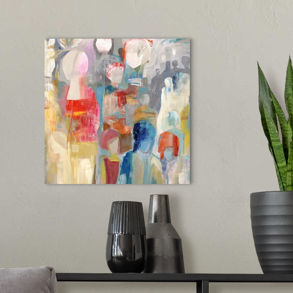 A modern room featuring Square abstract painting of colorful figures stacked together.