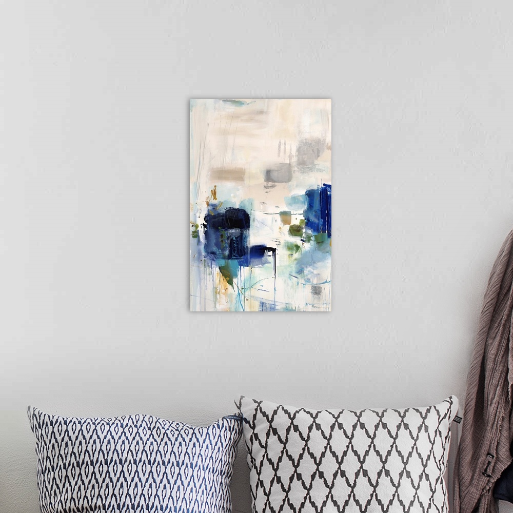 A bohemian room featuring Vertical abstract artwork with vivid squares of blue on white.