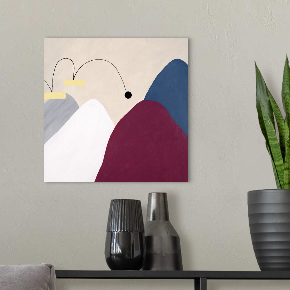A modern room featuring Contemporary abstract art of several mountains, each different in color, with a small ball that a...