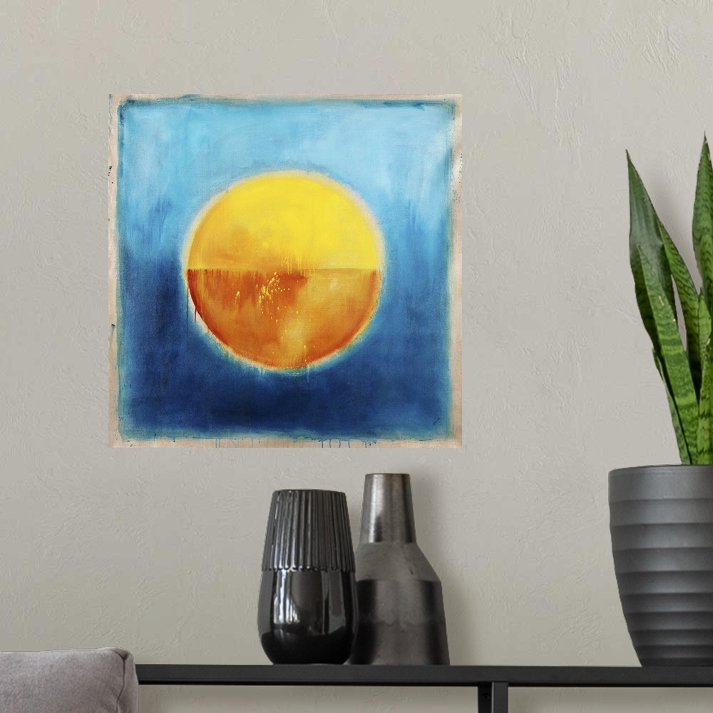 A modern room featuring Contemporary abstract painting using vibrant colors t make circle of gold in the center of a blue...