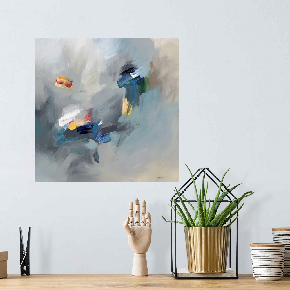 A bohemian room featuring Abstract artwork with bright spots of yellow and white on hazy blue and grey.