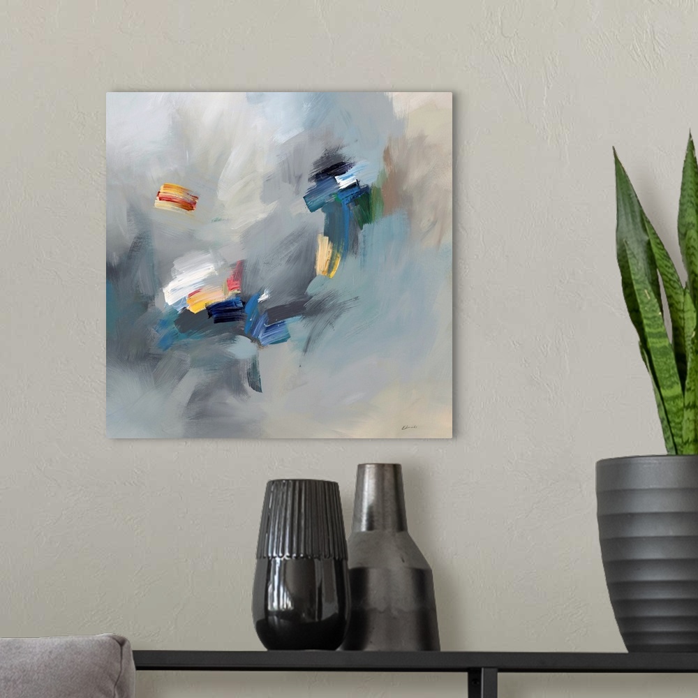 A modern room featuring Abstract artwork with bright spots of yellow and white on hazy blue and grey.