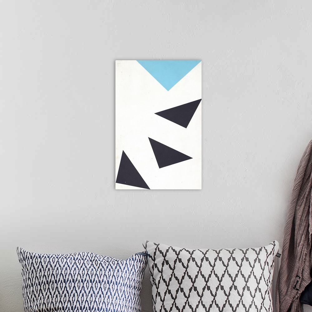 A bohemian room featuring Geometric abstract painting of blue and black triangles pointing down, following each other in a ...