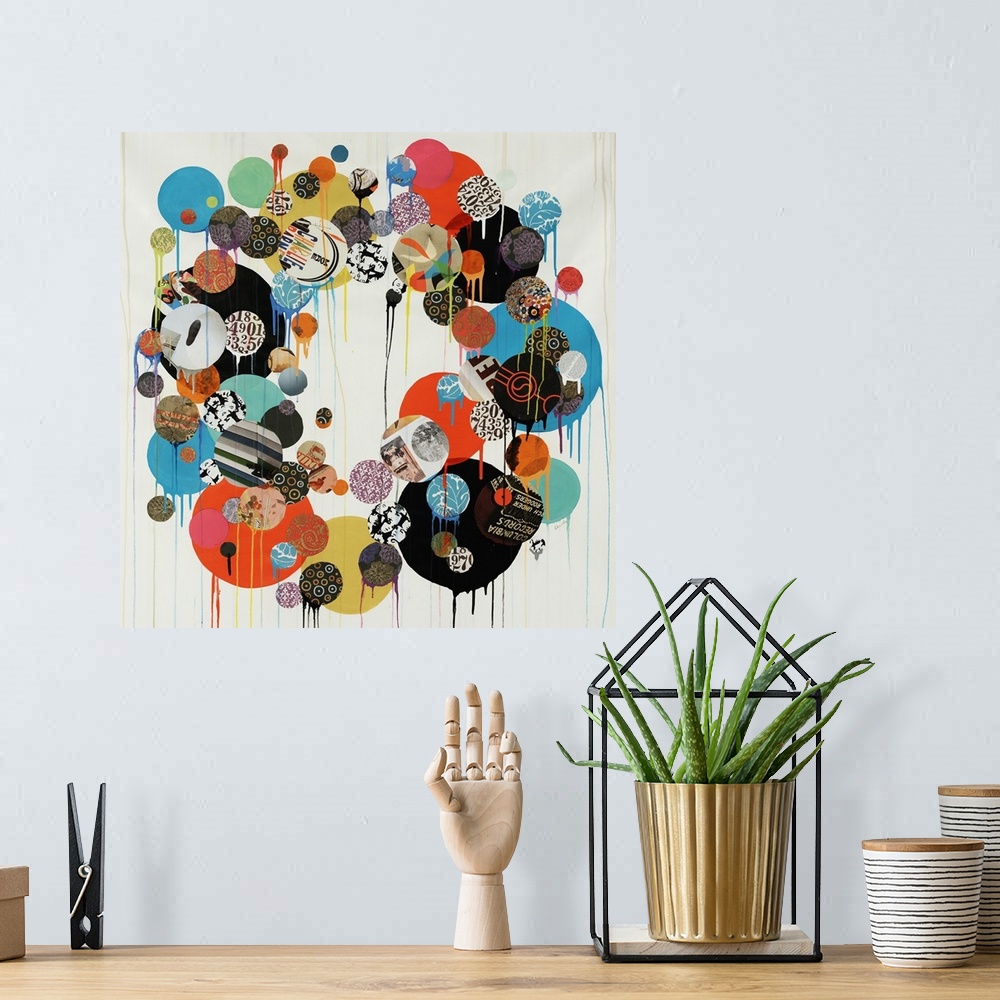 A bohemian room featuring Abstract contemporary wall art featuring a collage of cut-out and painted circles put together to...