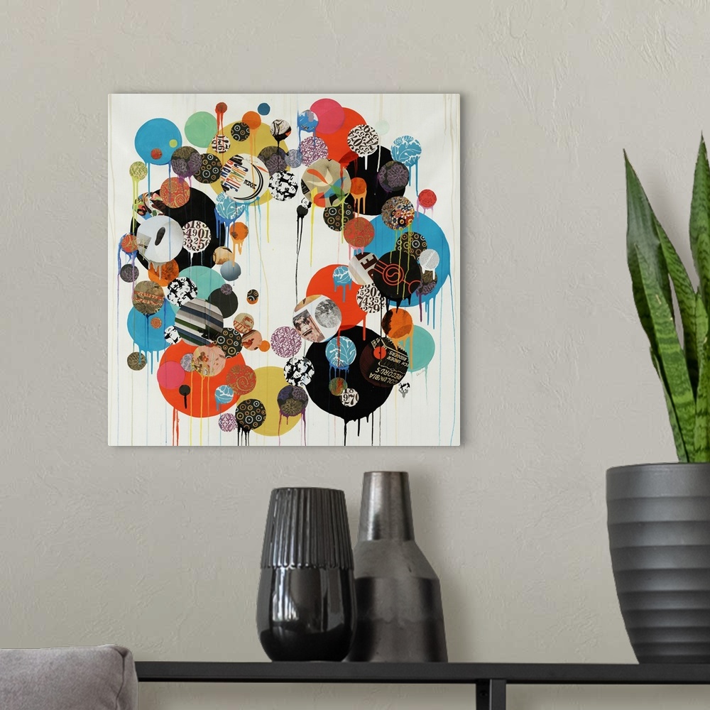 A modern room featuring Abstract contemporary wall art featuring a collage of cut-out and painted circles put together to...