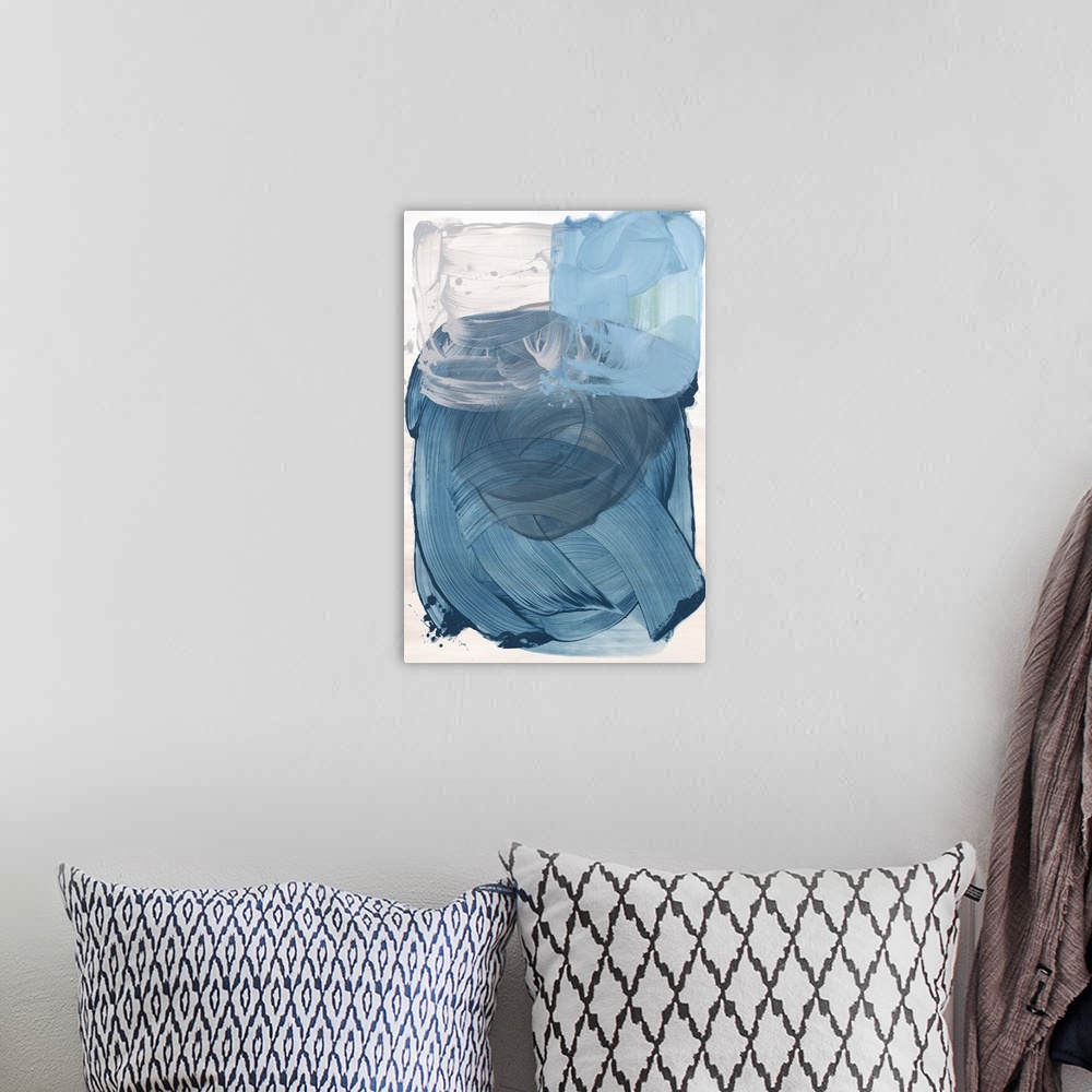 A bohemian room featuring Blue abstract artwork in a series of three primary color paintings.