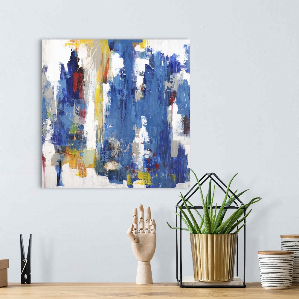 A bohemian room featuring Contemporary abstract painting using mostly blue in vertical swipes with pops of yellow against a...