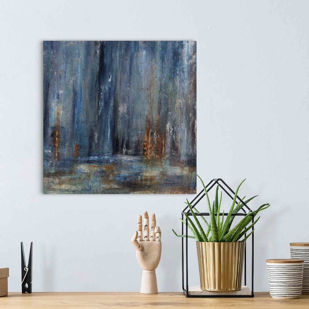 A bohemian room featuring Abstract painting with dark blue cascading down from the top of the image merging with earthy tones.