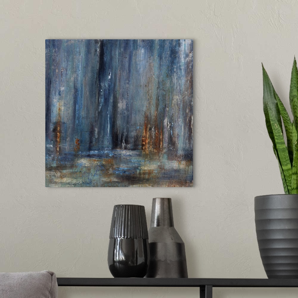 A modern room featuring Abstract painting with dark blue cascading down from the top of the image merging with earthy tones.