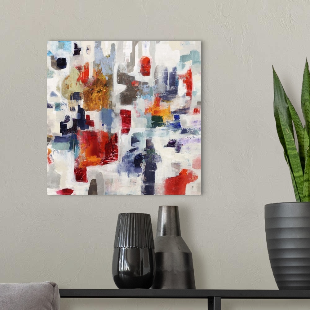 A modern room featuring Contemporary abstract painting with bright blocks of red and blue color against a pale background.