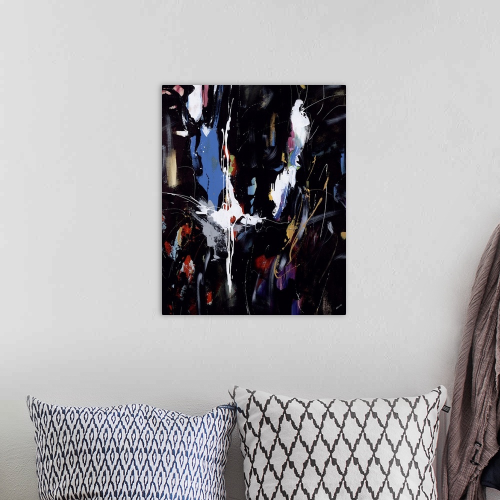 A bohemian room featuring Abstract painting of vibrant colors against a black background.