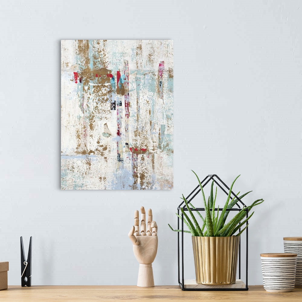 A bohemian room featuring Abstract painting with a white background and gold, light blue, and red hues on top.
